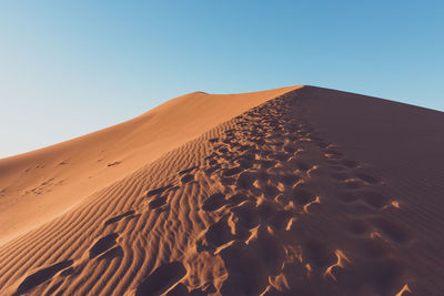 Scenic view of desert against clear sky