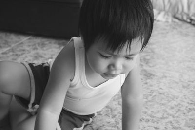 Close-up of cute boy sitting at home