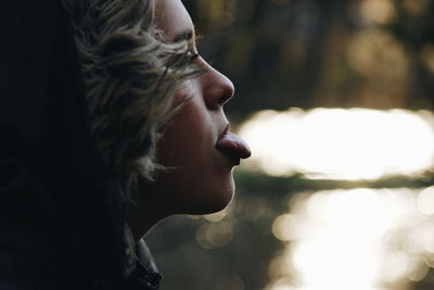 Close-up of girl sticking out tongue