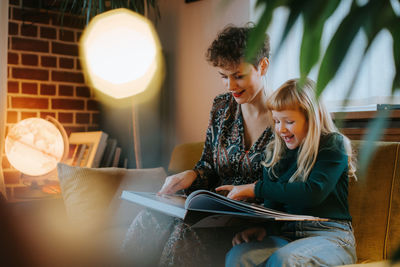 Mother and daughter are reading a book