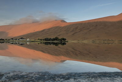 1128 sumu jaran lake and badain jaran desert temple-sand megadunes reflected on mirror water. china.