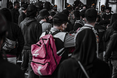 Rear view of people on street in city