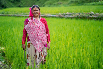 Portrait of mature woman standing at farm