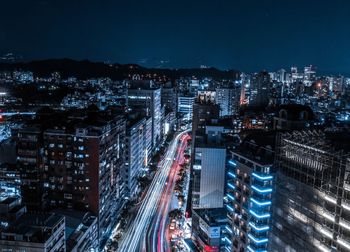 High angle view of illuminated city street and buildings at night