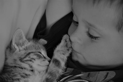 Kitten sleeping with boy at home