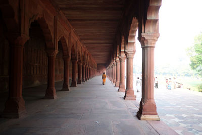 Rear view of woman walking in corridor