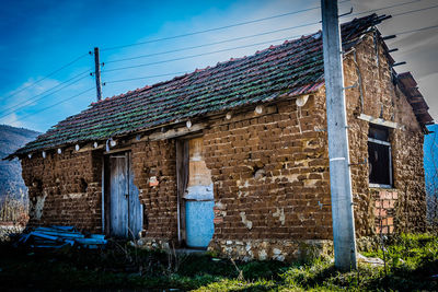 Abandoned house against blue sky