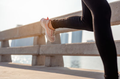 Low section of woman wearing shoes outdoors