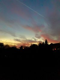 Silhouette trees against sky during sunset