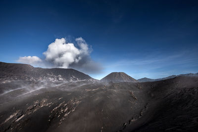 Smoke emitting from volcanic mountain against sky