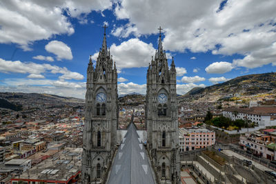 Church in town against cloudy sky