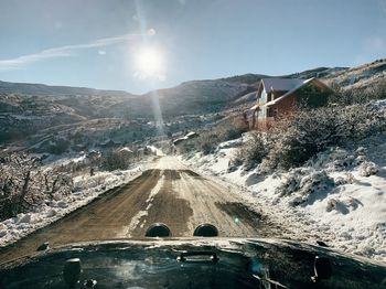 Snow covered road against sky