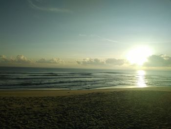 Scenic view of sea against bright sun