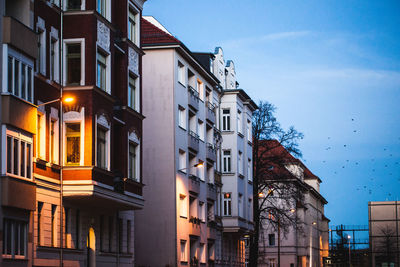 Low angle view of illuminated buildings against sky