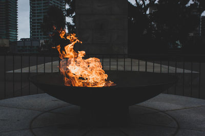 Close-up of fire burning against building