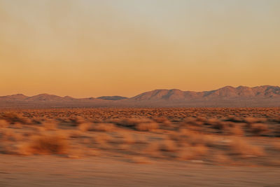 Scenic view of desert against sky during sunset