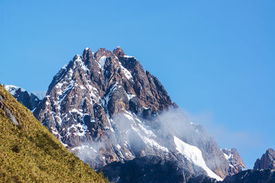 Scenic view of mountains against cloudy sky