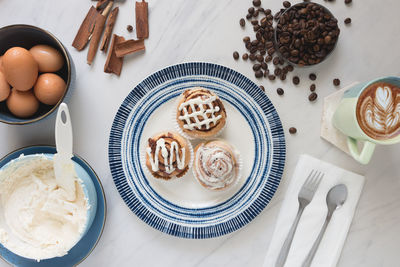 Cinnamon rolls, freshly baked on a plate kitchen tabletop - baking and home cooking concept image.