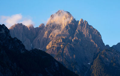 Scenic view of rocky mountains against sunrise sky