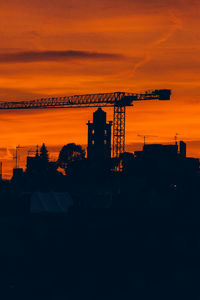 Silhouette of building against sky during sunset