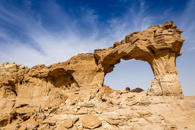 Low angle view of rock formation against sky