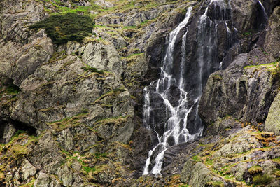 Scenic view of waterfall against rock formation