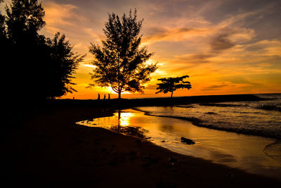 Scenic view of lake against orange sky