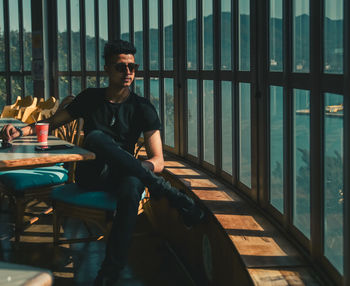 Young man sitting on table