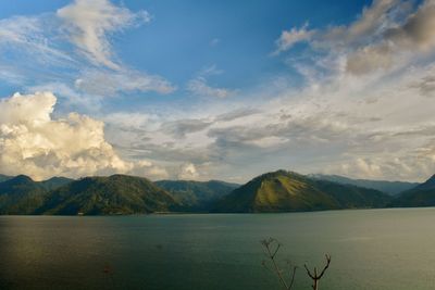 Scenic view of lake and mountains against sky