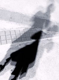 Shadow of person on footpath