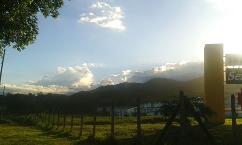 Fence on landscape against sky