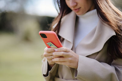 Midsection of woman using mobile phone