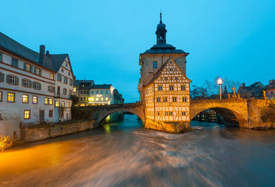 Arch bridge over river in city