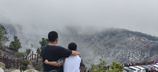 Rear view of man looking at mountains