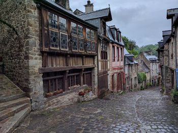 Street amidst houses against sky