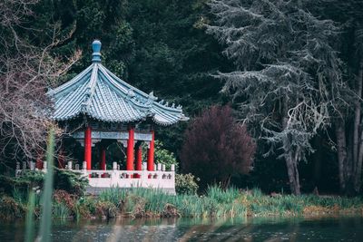 Gazebo by lake in forest