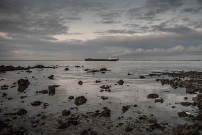 Scenic view of sea against cloudy sky