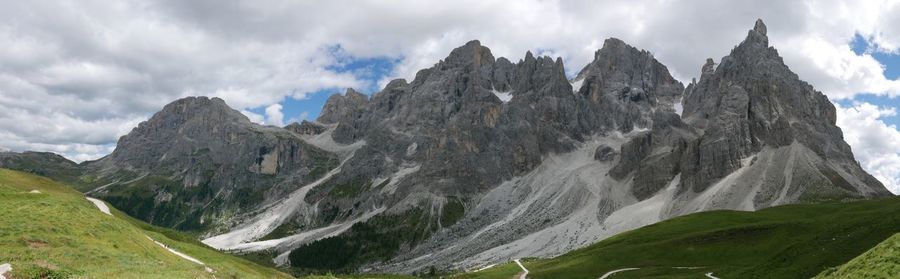 Scenic view of mountain range against cloudy sky