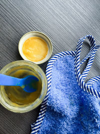 High angle view of baby food and bib on table