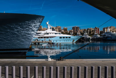 Scenic view of sea by buildings against blue sky