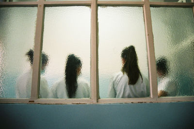 Woman looking through window