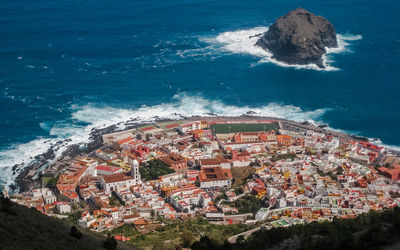 High angle view of buildings by sea