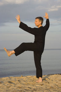 Man exercising on beach