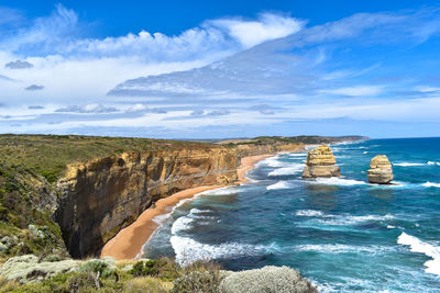 Scenic view of rocky coastline and sea against sky in australia