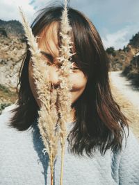 Rear view of woman standing against sky