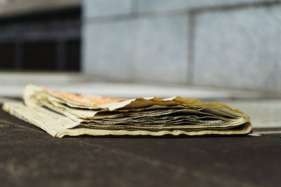 Close-up of newspaper on table