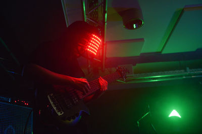 Close-up of man working on illuminated stage