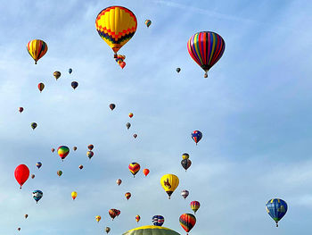 Low angle view of hot air balloons flying in sky