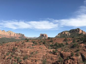 Rock formations on mountain against cloudy sky