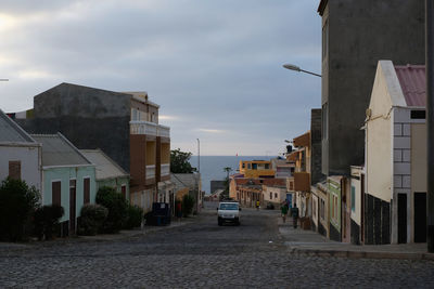 Street amidst buildings in city against sky